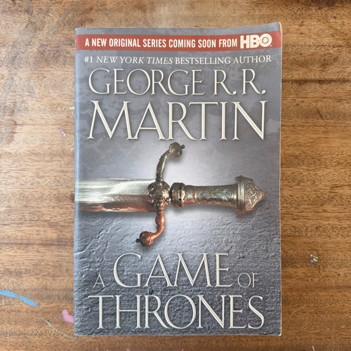 A book titled "A Game of Thrones" by George R.R.